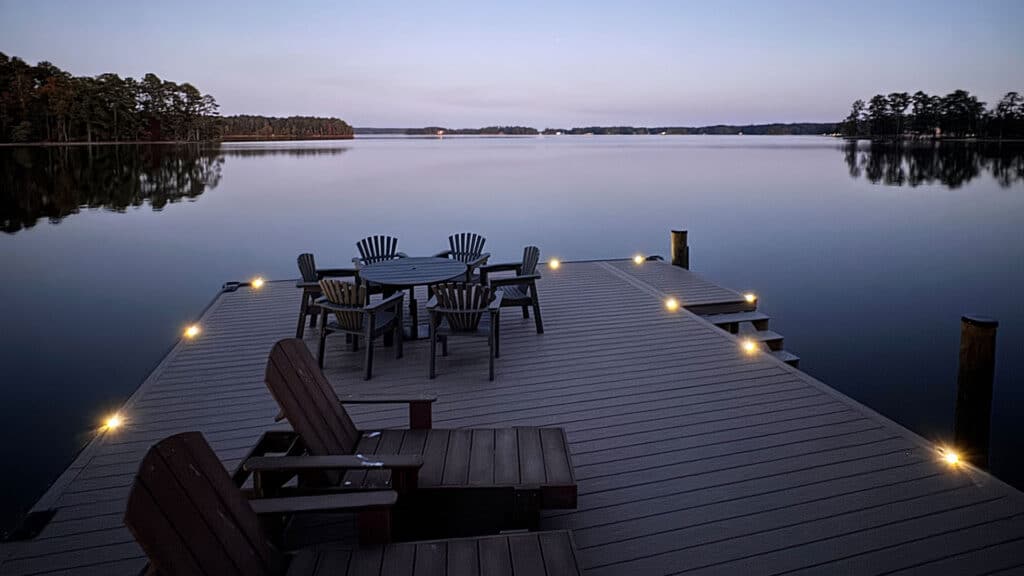 Dock with outdoor lighting at dusk, offering a serene view over calm water, perfect for evening relaxation.